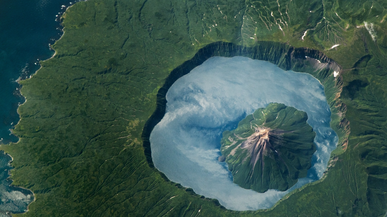 Earth from space: 'Lake of clouds' appears between volcanic nesting dolls in Russia via rare mirror-like phenomenon