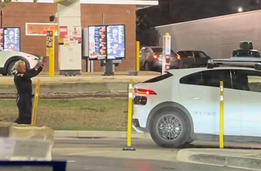 Police Officer Helplessly Waves Arms at Waymo That Careened Wrong Way Through Whataburger Drive-Thru